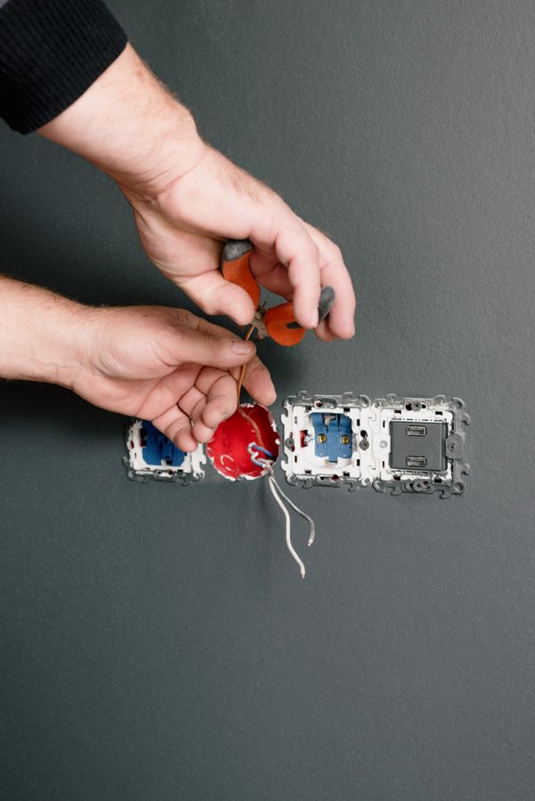 Electrician working on accessible domestic fixed electrical equipment