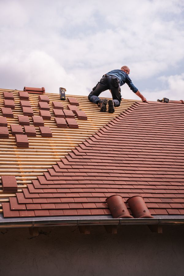 Roof coverings being inspected and repaired